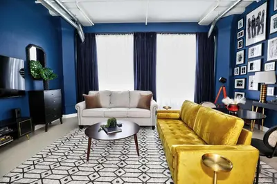 a living room with a yellow couch and blue walls at Downtown LA's Most Requested Property, Sleeps 4 with Free Parking! in Los Angeles