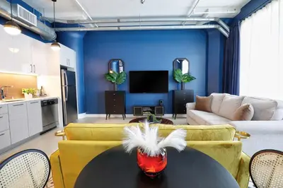 a living room with a black table and yellow chairs at Downtown LA's Most Requested Property, Sleeps 4 with Free Parking! in Los Angeles