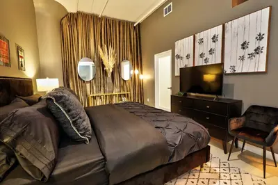 a bedroom with a bed and a flat screen tv at Downtown LA's Most Requested Property, Sleeps 4 with Free Parking! in Los Angeles
