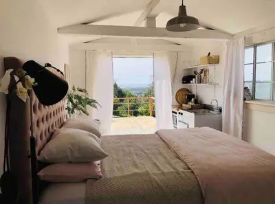 a bedroom with a bed and a large window at 30 PCT OFF! Malibu Charming Suite, Ocean View, King Bed in Malibu