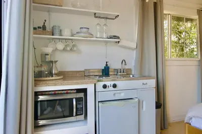 a kitchen with a sink and a microwave at 30 PCT OFF! Malibu Charming Suite, Ocean View, King Bed in Malibu