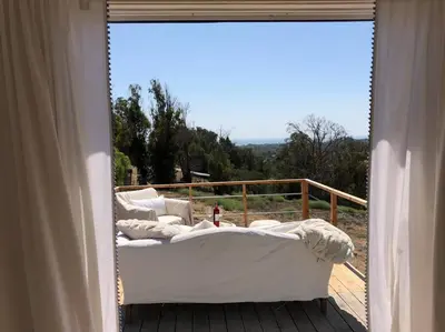 a room with two beds on a deck with a window at 30 PCT OFF! Malibu Charming Suite, Ocean View, King Bed in Malibu