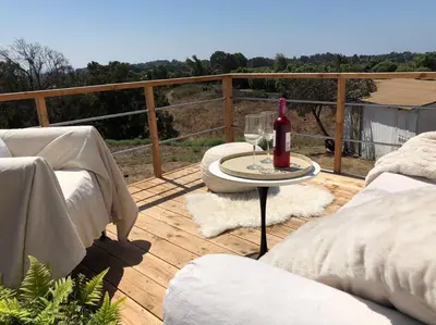 a wooden deck with a table and a bottle of wine at 30 PCT OFF! Malibu Charming Suite, Ocean View, King Bed in Malibu