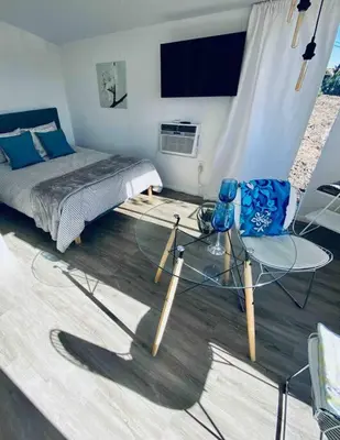 a bedroom with a bed and a glass table and chair at 30 PCT OFF! Malibu Serene Cabin, Ocean View, Beach in Malibu