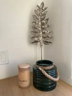 a plant in a vase on a table with a candle at 30 PCT OFF! Malibu Serene Cabin, Ocean View, Beach in Malibu