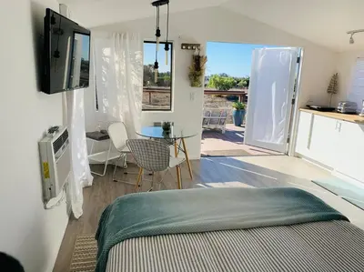 a room with a bed and a table and a kitchen at 30 PCT OFF! Malibu Serene Cabin, Ocean View, Beach in Malibu