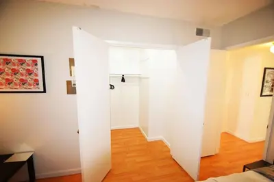 a white door in a room with a hallway at Hollywood Business Apartments in Los Angeles