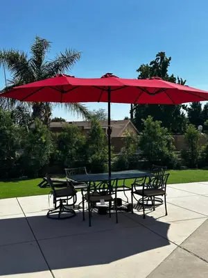 a table and chairs under a red umbrella at Buxton Private Room and Bath Wheel Chair Access in Rialto