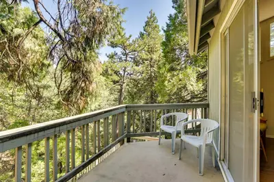 two chairs on a porch with trees in the background at Peaceful Pines Running Springs Home with 3 Decks in Running Springs