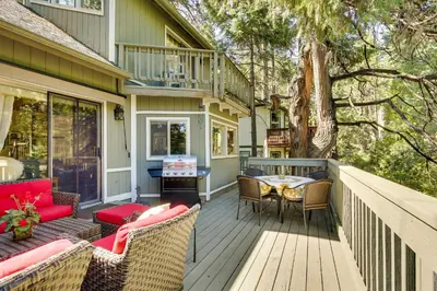 a deck with chairs and a table on a house at Peaceful Pines Running Springs Home with 3 Decks in Running Springs