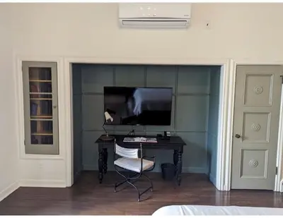 a room with a desk with a monitor and a chair at Villa Carlotta - 30 Day Requirement in Los Angeles