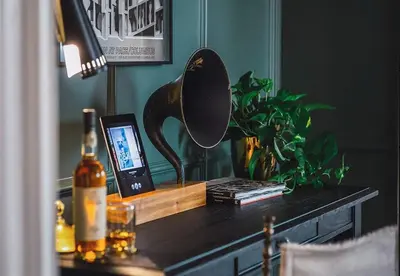 a table with a mirror and a bottle of wine at Villa Carlotta - 30 Day Requirement in Los Angeles