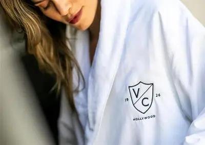 a woman wearing a white shirt with a pentagon on it at Villa Carlotta - 30 Day Requirement in Los Angeles