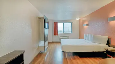 a bedroom with a white bed and a window at Suites Los Angeles CA Los Angeles LAX in Inglewood