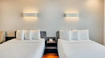 two beds sitting next to each other in a room at Suites Los Angeles CA Los Angeles LAX in Inglewood