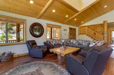 a living room with couches and a wooden ceiling at Elegant Big Bear Cabin Half Mi to Big Bear Lake! in Big Bear Lake