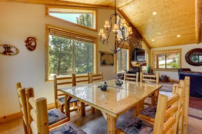 a dining room with a wooden table and chairs at Elegant Big Bear Cabin Half Mi to Big Bear Lake! in Big Bear Lake
