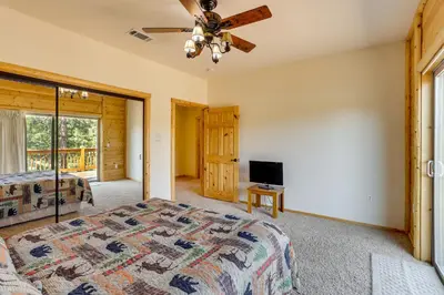 a bedroom with a bed and a flat screen tv at Elegant Big Bear Cabin Half Mi to Big Bear Lake! in Big Bear Lake