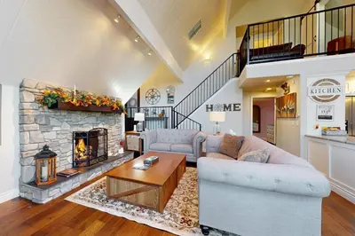 a living room with a couch and a fireplace at Surreal Feel Lakeview Chalet in Lake Arrowhead