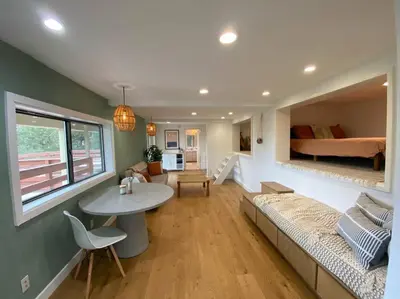 a living room with a couch and a table and a bed at Apartment with Private Deck & Mountain Views in Topanga