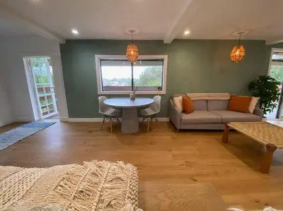 a living room with a couch and a table at Apartment with Private Deck & Mountain Views in Topanga