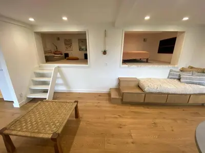 a living room with a bed and a stair case at Apartment with Private Deck & Mountain Views in Topanga