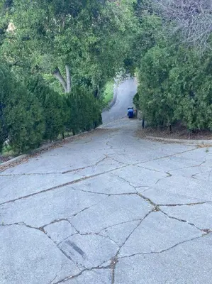 an empty road with a blue trash can on it at Apartment with Private Deck & Mountain Views in Topanga