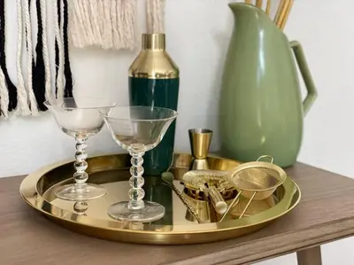 a tray with glasses and a bottle on a table at @wild_olive_den ~ Serene Weekend Getaway Cabin in Running Springs