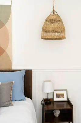 a bedroom with a bed and a table with a lamp at Wild Olive Lodge ° Serene grandma chíc getaway cabin in Running Springs