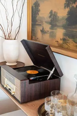 a stereo on a table with a vase and glasses at Wild Olive Lodge ° Serene grandma chíc getaway cabin in Running Springs