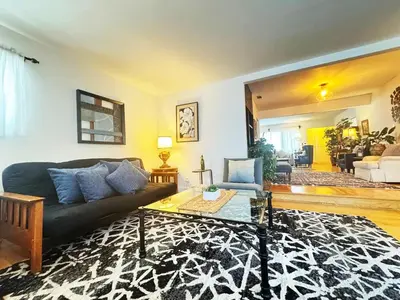 a living room with a couch and a table at Charming 3BR House - Hal-UC in Los Angeles