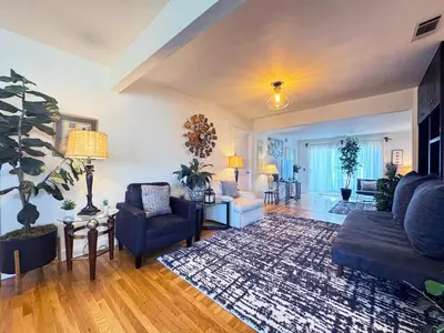 a large living room with a blue couch and chairs at Charming 3BR House - Hal-UC in Los Angeles
