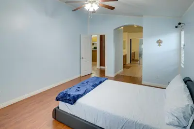 a bedroom with a bed and a ceiling fan at Pet-Friendly California Retreat with Fenced-In Yard! in Bakersfield