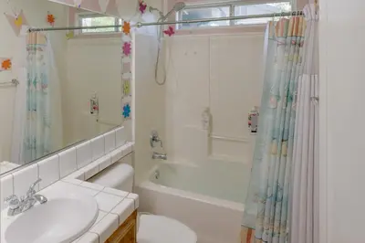a bathroom with a tub and a sink and a shower at Pet-Friendly California Retreat with Fenced-In Yard! in Bakersfield