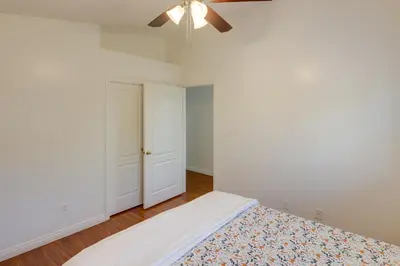 a bedroom with a bed and a ceiling fan at Pet-Friendly California Retreat with Fenced-In Yard! in Bakersfield