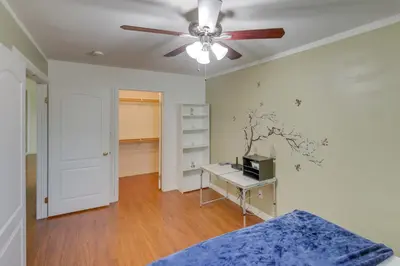 a bedroom with a ceiling fan and a desk at Pet-Friendly California Retreat with Fenced-In Yard! in Bakersfield