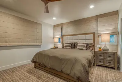 a bedroom with a large bed and a night stand at Lake Front Modern Luxury in Lake Arrowhead
