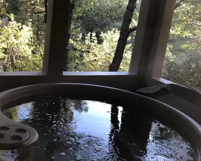 a bath tub in a room with two windows at Lake Front Modern Luxury in Lake Arrowhead