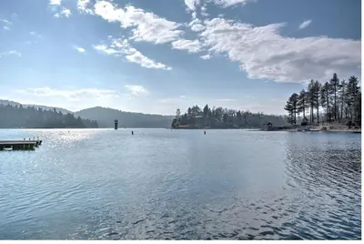 a large lake with a dock in the middle of it at Lake Front Modern Luxury in Lake Arrowhead
