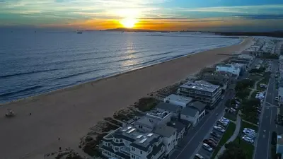 an aerial view of the beach at sunset at 3 Bedroom 2 Bath Beachfront Home in Huntington Beach