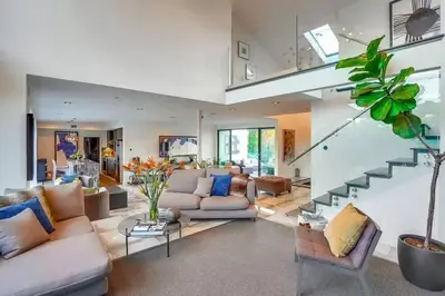 a living room with couches and a staircase at Troy Hill in Los Angeles