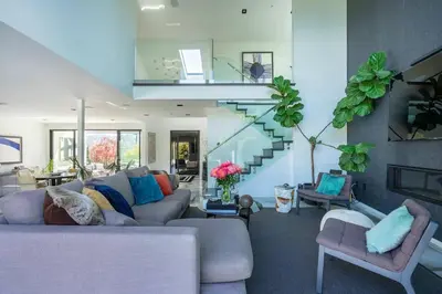 a living room with a couch and a staircase at Troy Hill in Los Angeles