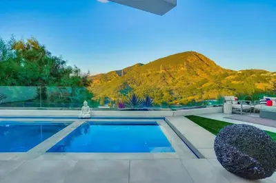 a swimming pool with a mountain in the background at Troy Hill in Los Angeles