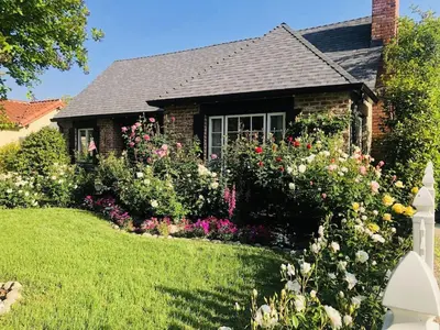 a garden in front of a house with flowers at Charming Pasadena English Cottage on Tree Lined Street in Pasadena