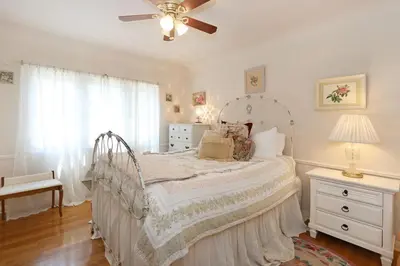 a bedroom with a bed and a ceiling fan at Charming Pasadena English Cottage on Tree Lined Street in Pasadena
