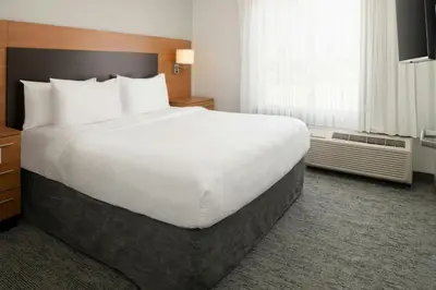 a large white bed in a hotel room at TownePlace Suites by Marriott Lancaster in Lancaster