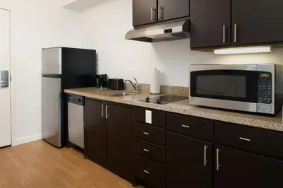 a kitchen with a microwave and a refrigerator at TownePlace Suites by Marriott Lancaster in Lancaster