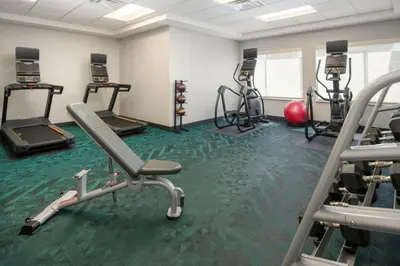 a gym with treadmills and exercise equipment on the floor at TownePlace Suites by Marriott Lancaster in Lancaster