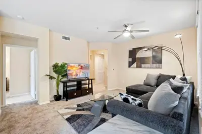 a living room with a couch and a flat screen tv at Lovely & coxy 2BR/2BA! 5MIN to Disney! in Anaheim