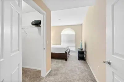 a bedroom with a bed and a room with a door at Lovely & coxy 2BR/2BA! 5MIN to Disney! in Anaheim